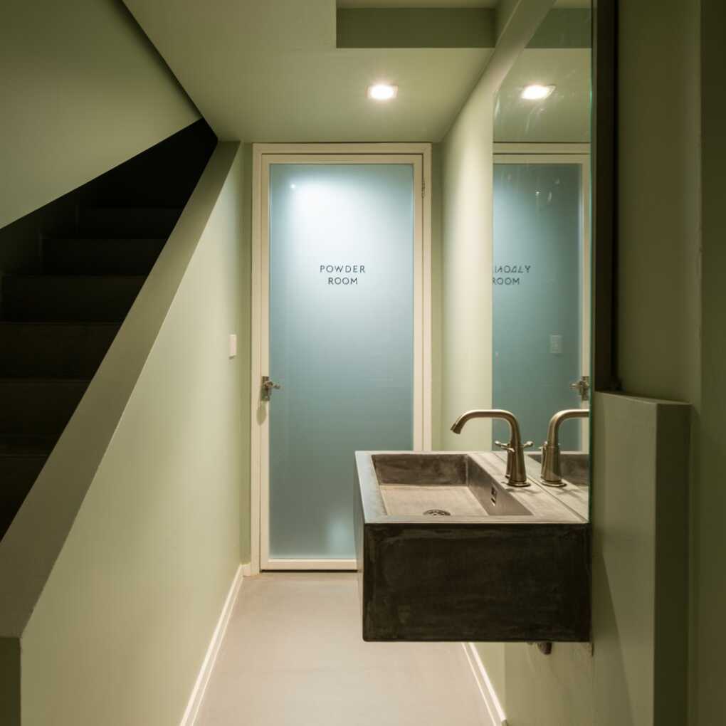 Under Stairs Powder Room with a Floating Sink