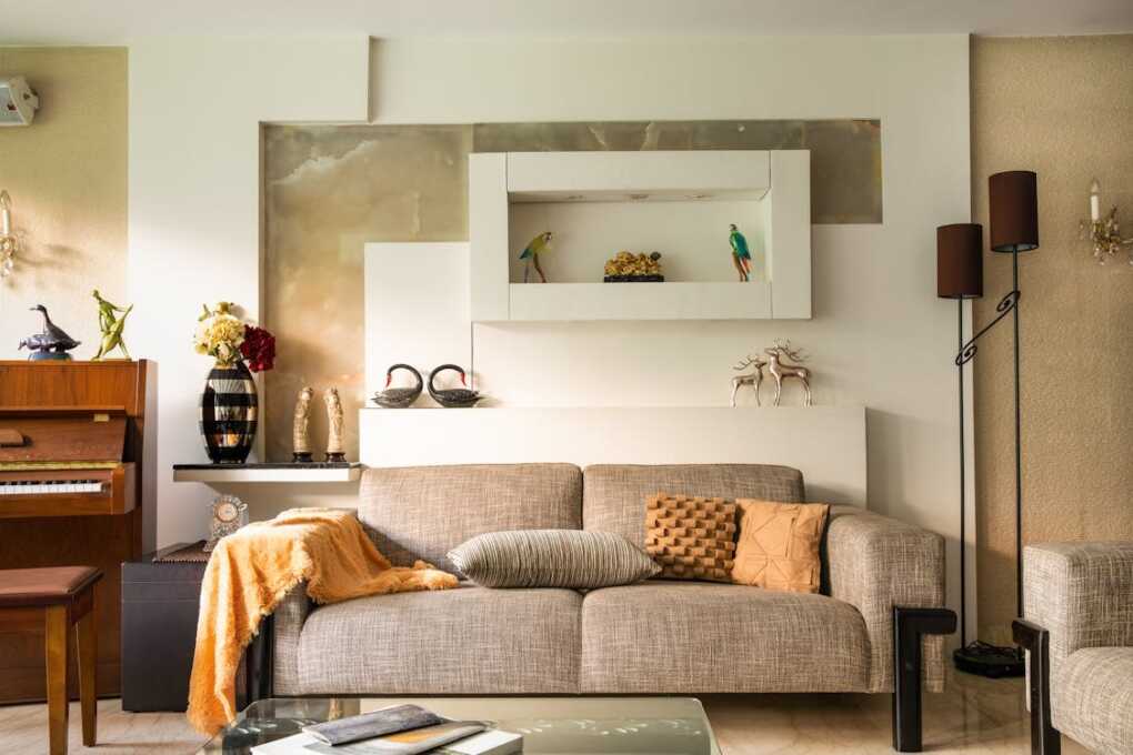 Free Cozy living room featuring a sofa, decorative items, and a piano, perfect for a stylish home interior. Stock Photo