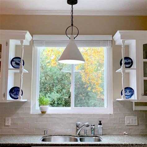 Cleaning a pendant ceiling light over a sink