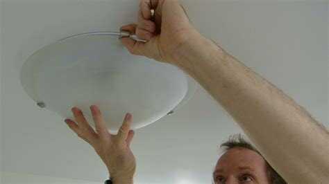 Removing a glass ceiling light shade in a kitchen